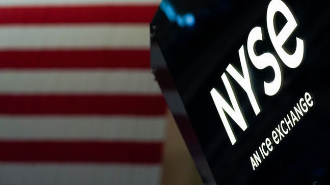 FILE - An NYSE sign is seen on the floor at the New York Stock Exchange in New York, Wednesday, June 15, 2022. (AP Photo/Seth Wenig, File)